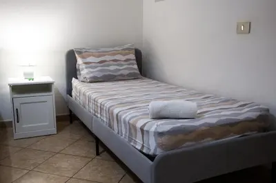 a small bed in a corner of a room at La Casetta della Nonna in Palermo