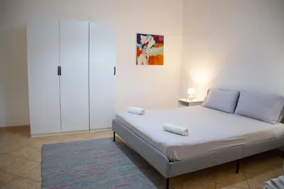 a bedroom with a bed and a painting on the wall at La Casetta della Nonna in Palermo