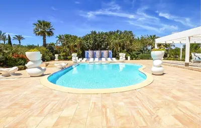 a swimming pool in a patio with chairs and a table at Nice Home In Partinico With Wifi in Partinico