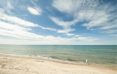 a beach with the ocean and a cloudy sky at Nice Home In Partinico With Wifi in Partinico
