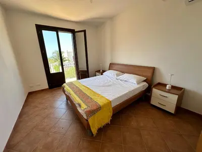 a small bedroom with a bed and a window at Casa Vacanza Villa Corona in San Vito lo Capo