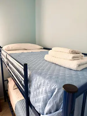 a bed with towels on it in a bedroom at Appartamento Trinacria in Castellammare del Golfo
