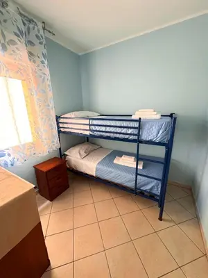 a small room with two bunk beds and a window at Appartamento Trinacria in Castellammare del Golfo