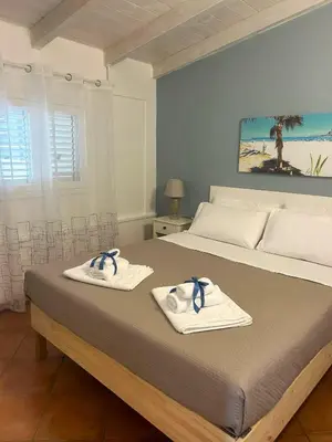 a bedroom with a bed with towels on it at Monte Luna - E-bikes incluse per raggiungere il centro e la spiaggia in 3 minuti in San Vito lo Capo