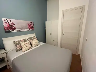 a small bedroom with a white bed with pillows at Monte Luna - E-bikes incluse per raggiungere il centro e la spiaggia in 3 minuti in San Vito lo Capo