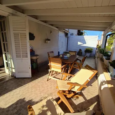 a patio with a table and chairs on a porch at La Terrazza su Mondello in Palermo