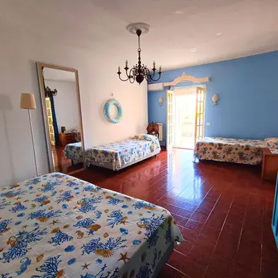 a bedroom with two beds and a mirror at La Terrazza su Mondello in Palermo