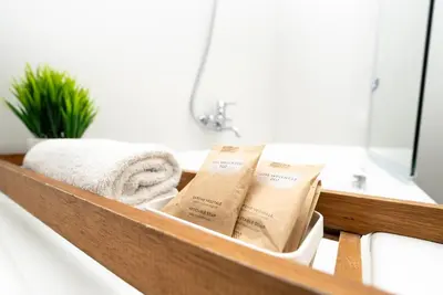 a bathroom counter with towels and a sink at Maison d'art Orleans in Palermo