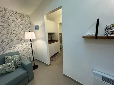 a living room with a couch and a wall at ArcorosaApartment Palermo Centro in Palermo