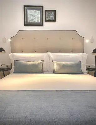a bedroom with a large white bed with two pillows at Normanni 5 Rooms & Apartment in Palermo
