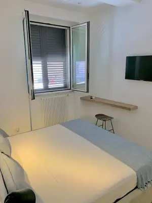 a bedroom with a large bed and a window at Normanni 5 Rooms & Apartment in Palermo