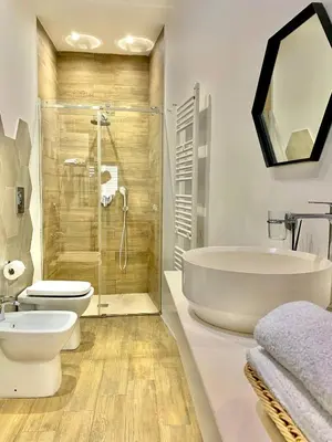 a bathroom with a tub and a toilet and a sink at Normanni 5 Rooms & Apartment in Palermo