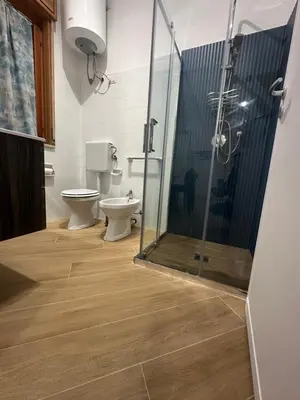 a bathroom with a toilet and a sink and a shower at casa consiglio ardicula in Terrasini