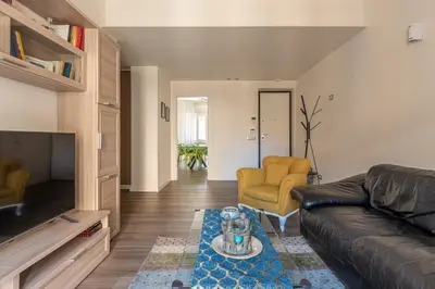 a living room with a couch and a chair at Appartamento Pacini by Wonderful Italy in Palermo