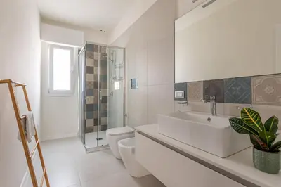 a white bathroom with a sink and a toilet at Appartamento Pacini by Wonderful Italy in Palermo