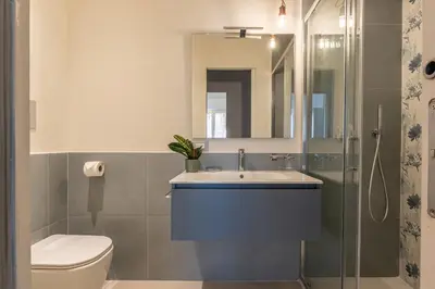 a bathroom with a sink and a toilet and a shower at Appartamento Pacini by Wonderful Italy in Palermo