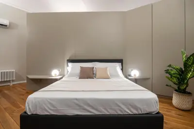 a bedroom with a large bed with white sheets at Maruisa suite apartment in Palermo