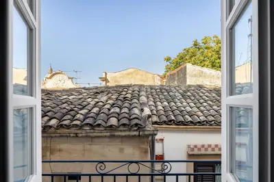 an open window with a view of a roof at Maruisa suite apartment in Palermo