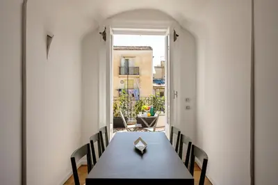 a dining room with a table and chairs at Maruisa suite apartment in Palermo