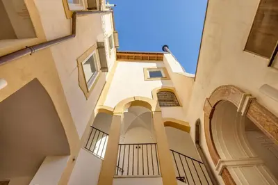 an alleyway in a building with arches at Maruisa suite apartment in Palermo
