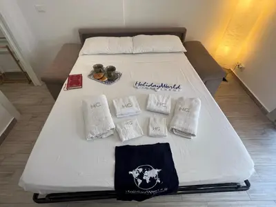 a bed with white sheets and pillows on it at Home al Capo by Holiday World in Palermo