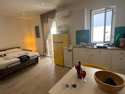 a room with a bed and a kitchen with a table at Home al Capo by Holiday World in Palermo