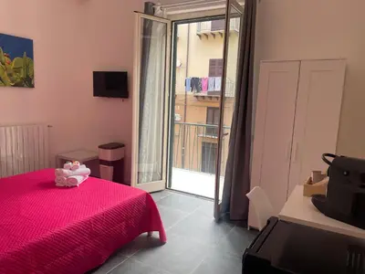 a bedroom with a pink bed with a pink blanket at My Happy Place Rooms in Palermo