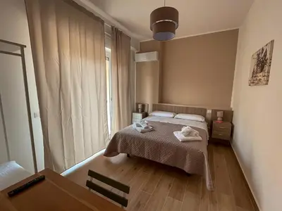 a bedroom with a bed with two towels on it at Casa Margherita in Termini Imerese