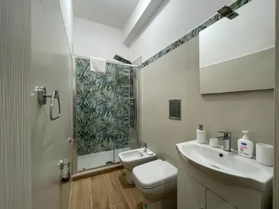a bathroom with a shower and a toilet and a sink at Casa Margherita in Termini Imerese