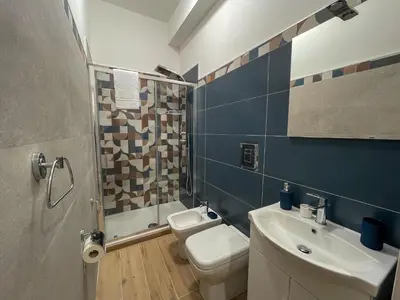 a bathroom with a toilet and a sink at Casa Margherita in Termini Imerese