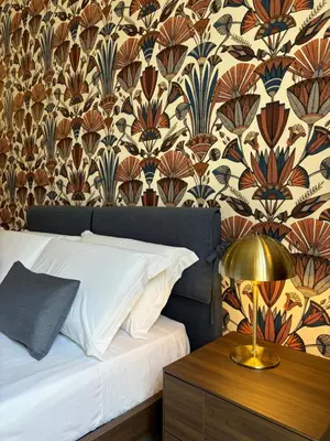 a bedroom with a bed and a table with a lamp at Galioto Sperlinga Luxury Boutique Apartments in Palermo