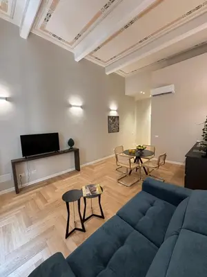 a living room with a couch and a table at Galioto Sperlinga Luxury Boutique Apartments in Palermo