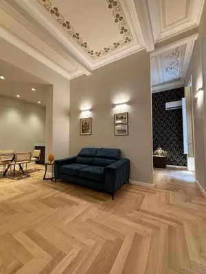 a living room with a black couch and a ceiling at Galioto Sperlinga Luxury Boutique Apartments in Palermo