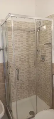 a shower stall in a bathroom with a toilet at new suite in Palermo