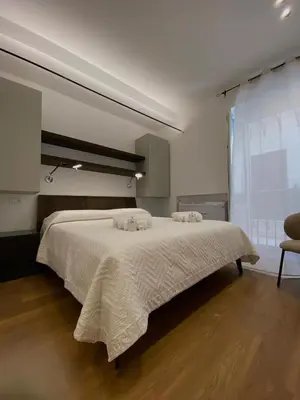 a white bedroom with a large bed in a room at B&B Sulle Vie del Capo in Palermo
