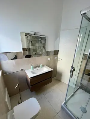 a bathroom with a sink and a glass shower at Casa Delle Femmine in Isola delle Femmine