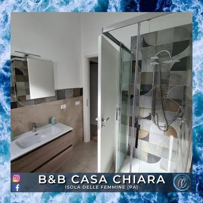 a bathroom with a sink and a glass shower at Casa Delle Femmine in Isola delle Femmine