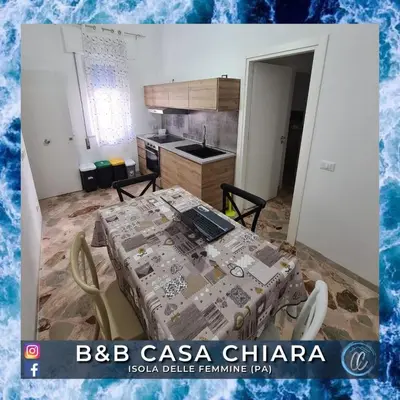 a kitchen with a table with a laptop on it at Casa Delle Femmine in Isola delle Femmine