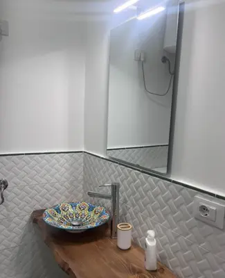 a bathroom with a table with a plate on it at Le stanze di Rosalia in Palermo