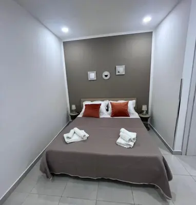 a bed with two towels and two pillows on it at Le stanze di Rosalia in Palermo