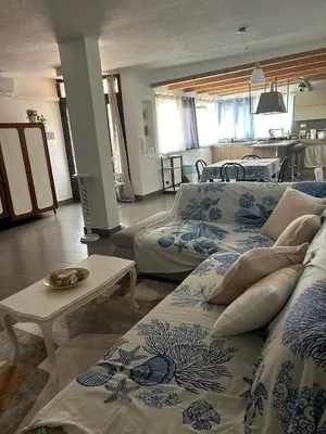 a living room with three beds and a table at Finc house in Palermo