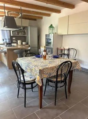 a dining room table with chairs and a kitchen at Finc house in Palermo