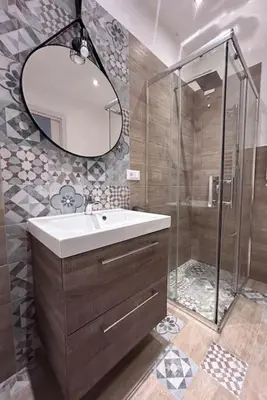 a bathroom with a sink and a shower with a mirror at Finc house in Palermo
