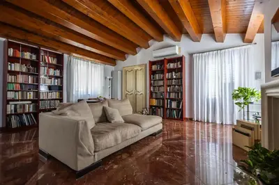 a living room with a couch and some books at iFlat Sicilia Le terrazze blu in Palermo