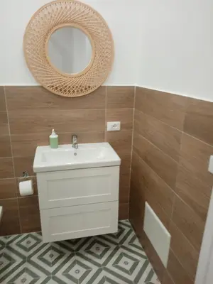 a bathroom with a sink and a mirror at Mediterranea casa vacanza in Capaci
