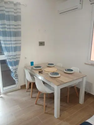 a dining room with a table and chairs at Mediterranea casa vacanza in Capaci