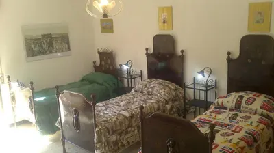 a room with two beds in a room at Casa Gelferraro in Calatafimi