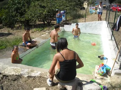a group of people playing in a swimming pool at Casa Gelferraro in Calatafimi