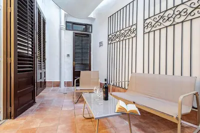 a living room with a bench and a table at Liberty Boutique Apartment in Palermo