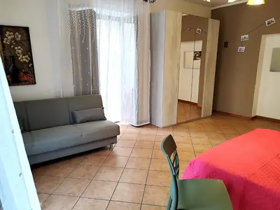 a living room with a couch and a bed at Rimpetto alle Clarisse in Palermo
